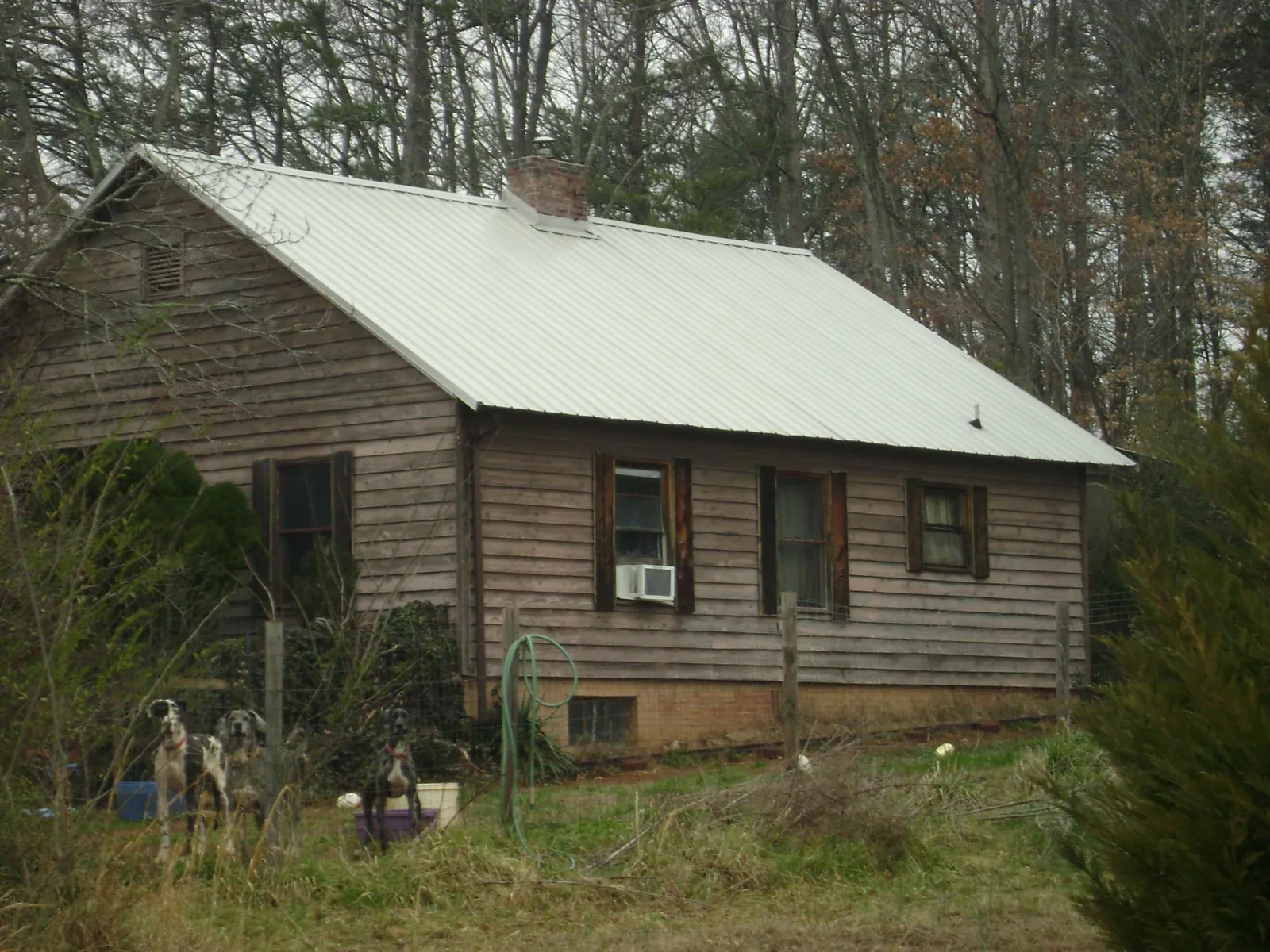 White metal roof on an old wood sided farmhouse, from a Metal Roof Installation job in Lockbourne